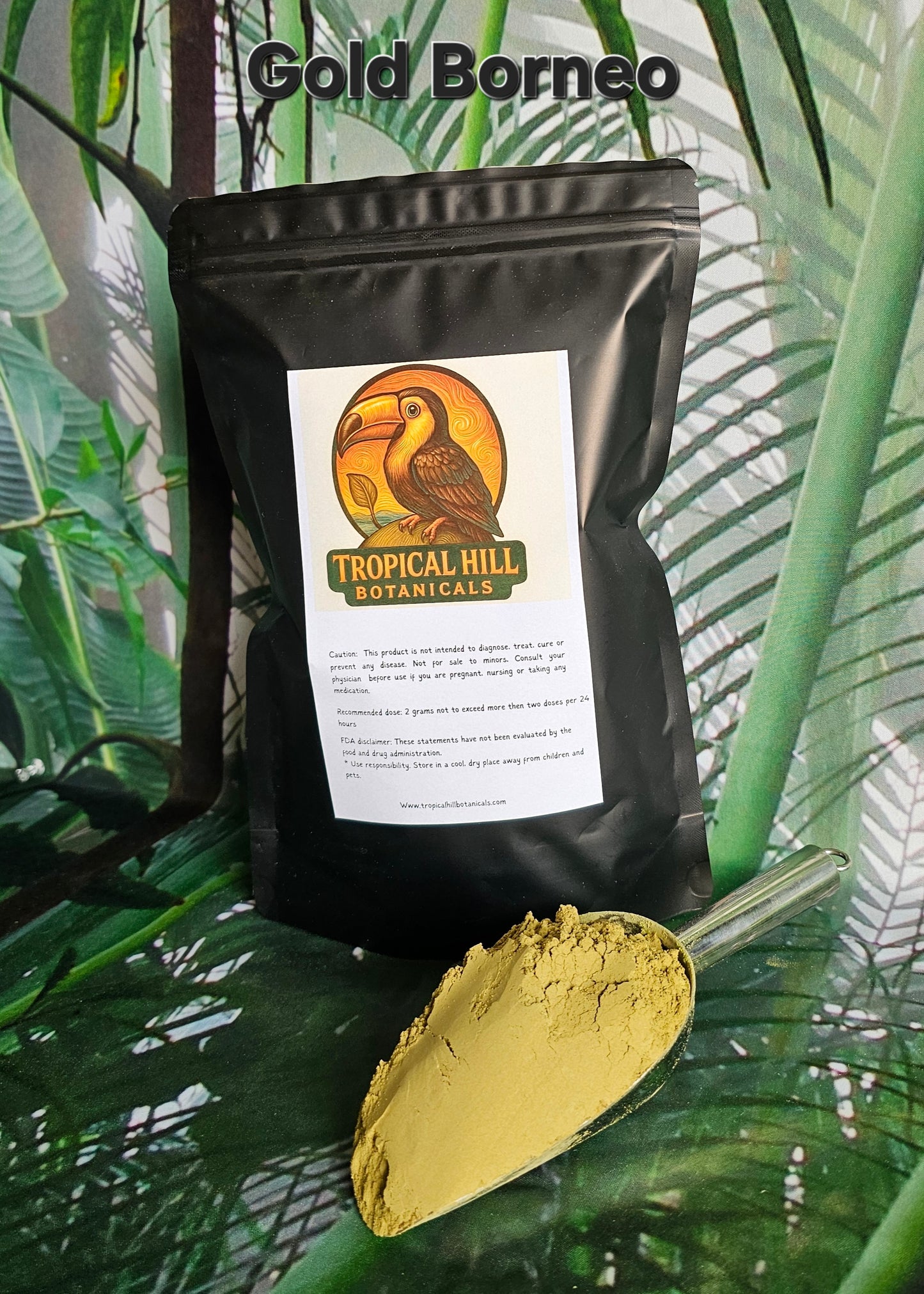 Gold Borneo strain above black pouch with 'Tropical Hill Botanicals' label on a green leafy background, scoop of light gold kratom powder