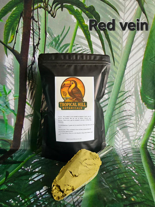 Red Horn powder in a large scoop in front of a Tropical Hill Botanicals bag with the Red Vein label shown above.